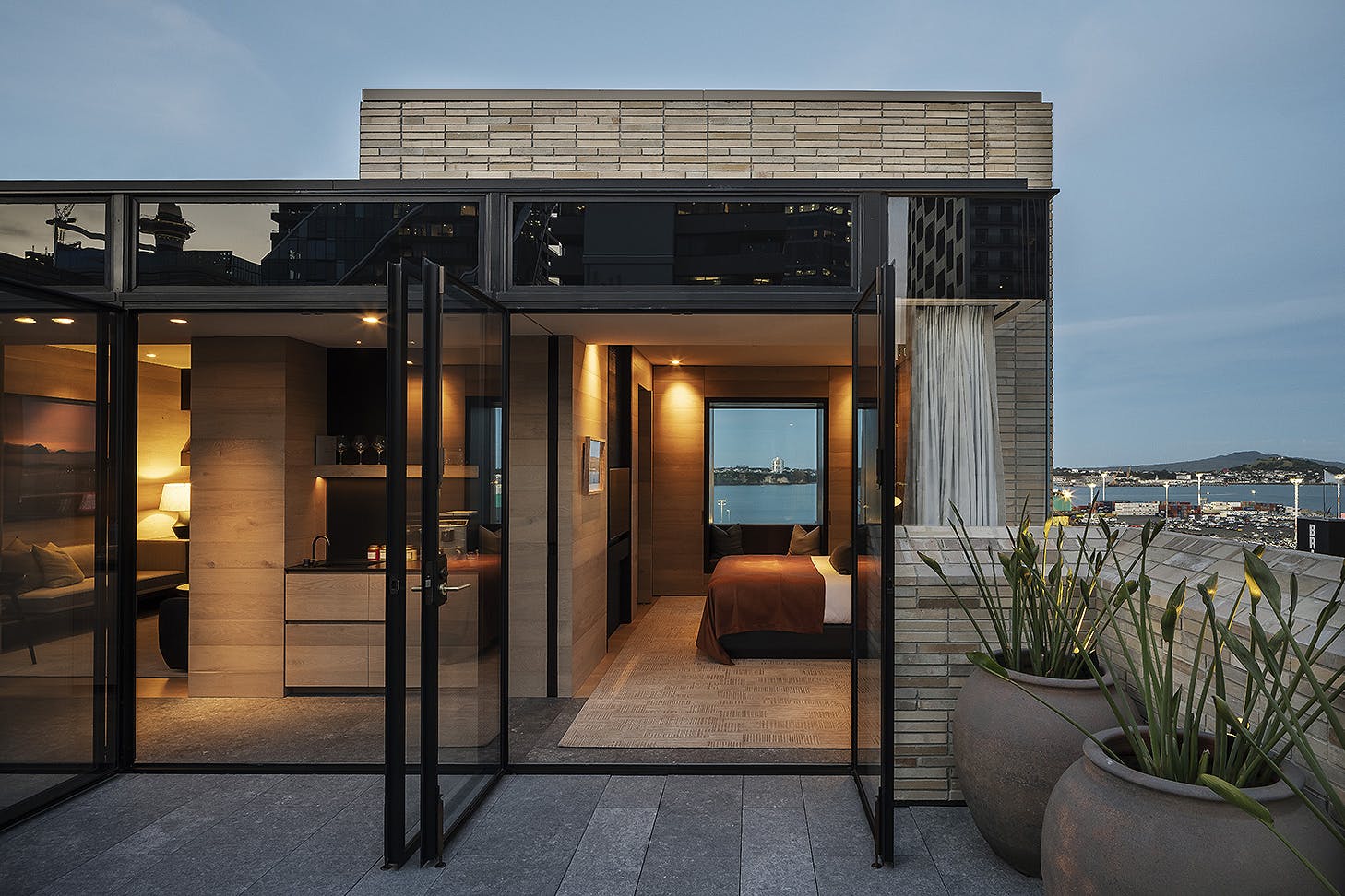 A room looks out at Rangitoto at dusk.